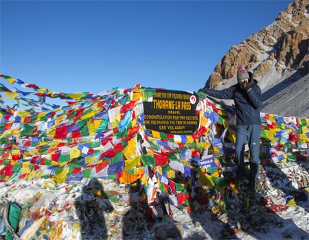 trekker at thorong la pass to cross long walking distance of annapurna circuit trek.