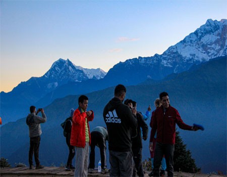 trekkers waiting sunrise at poon hill, early morning view from this hill station.
