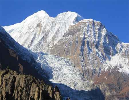 gangapurna mountain view from manang with the blue sky on a clear day during the annapurna circuit trek.