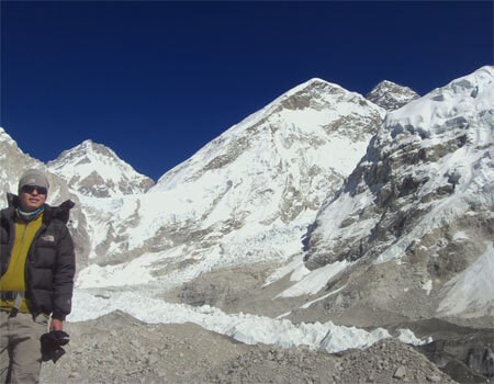 everest himalaya on a clear day in october, a guide is enjoying the view.
