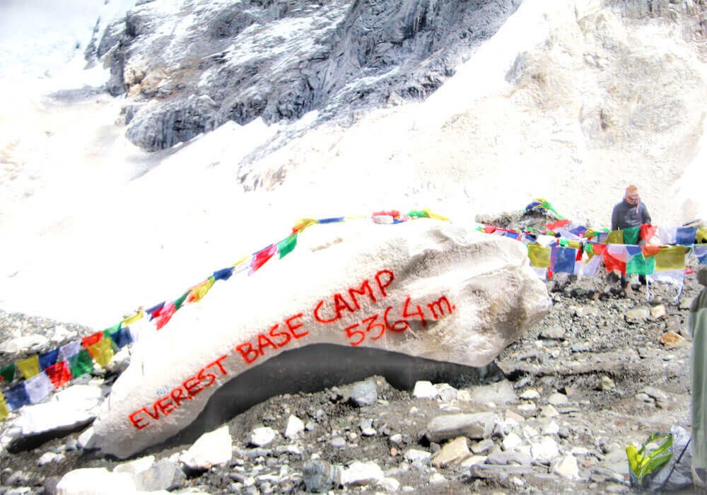 everest base camp written on a big stone on the khumbu glacier