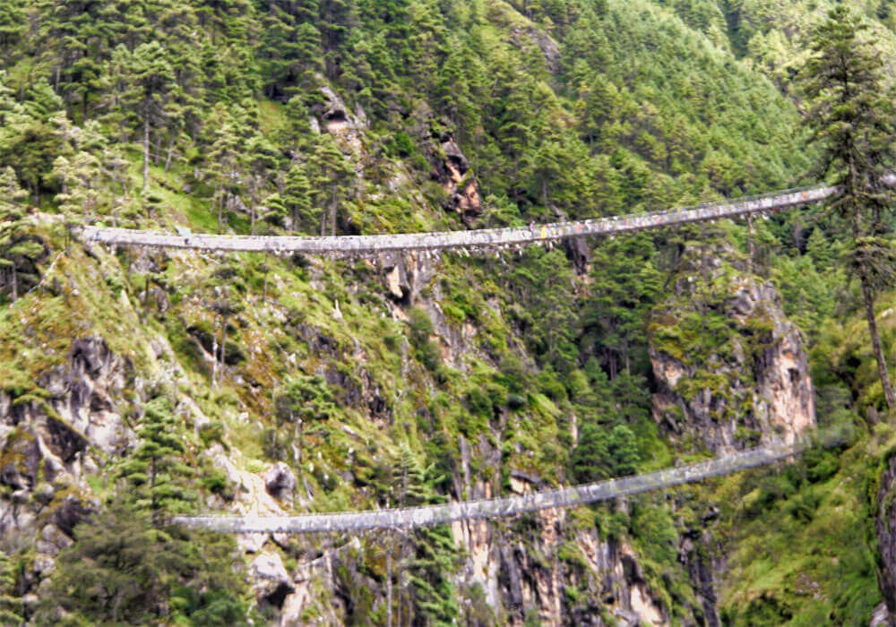 highest suspension bridge on everest base camp route, pine trees and prayer flags
