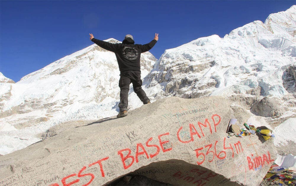 a trekker at everest base camp, beautiful mountain view and blue sky on budget everest base camp trek.