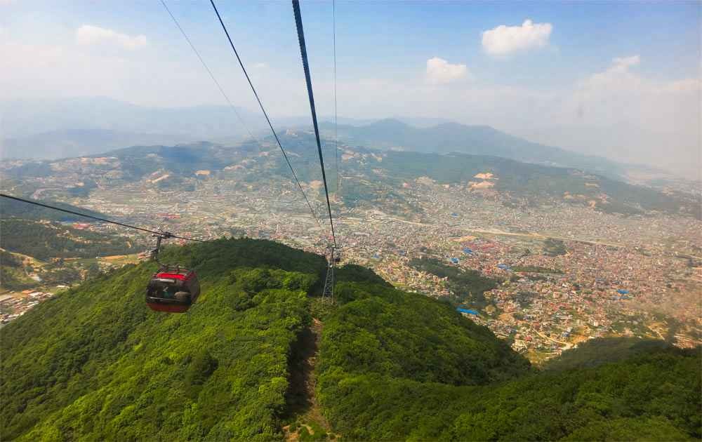 Magnificent views of Kathmandu Valley from cable car during Chandragiri Hill tour.