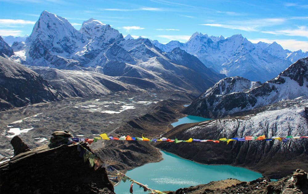 beautiful view of the mountains in everest himalayas, tranquil gokyo lakes and ngozumba glacier with prayer flags at gokyo ri in gokyo lakes trek.