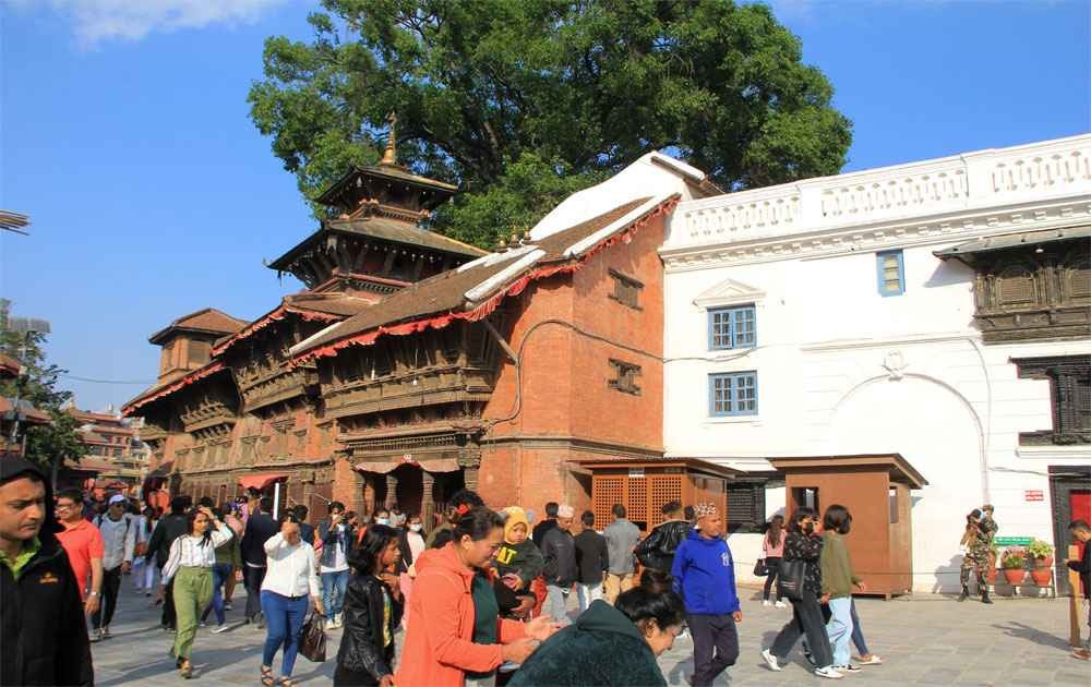 traditional architectural buildings with artistic wood carving in kathmandu ancent royal palace and visitors during heritage walking tour in kathmandu