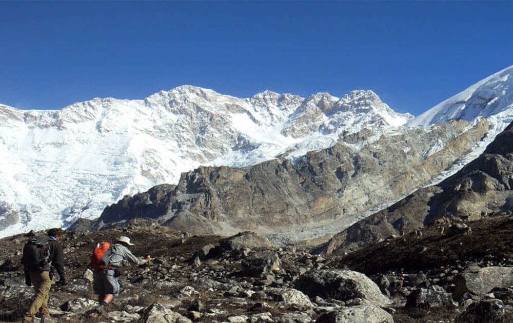 trekkers are heading to kanchenjunga south base camp, mt.kanchenjunga and blue sky on a clear day in kanchenjunga south base camp trek.