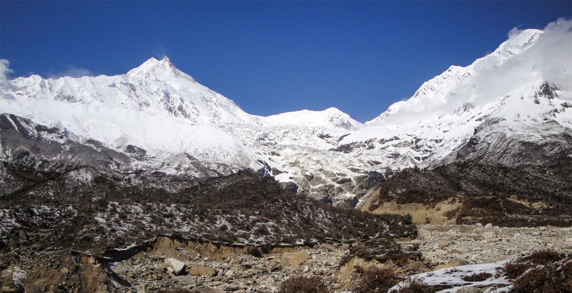 Mount Manaslu view from Samagaun with the blue sky while finishing total Manaslu Circuit Trekking distance.