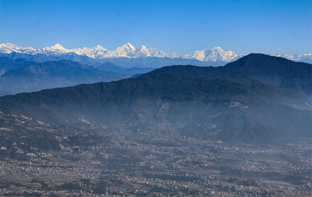 white mountains and kathmandu valley views with the blue sky on a clear day from bhasmasur hill