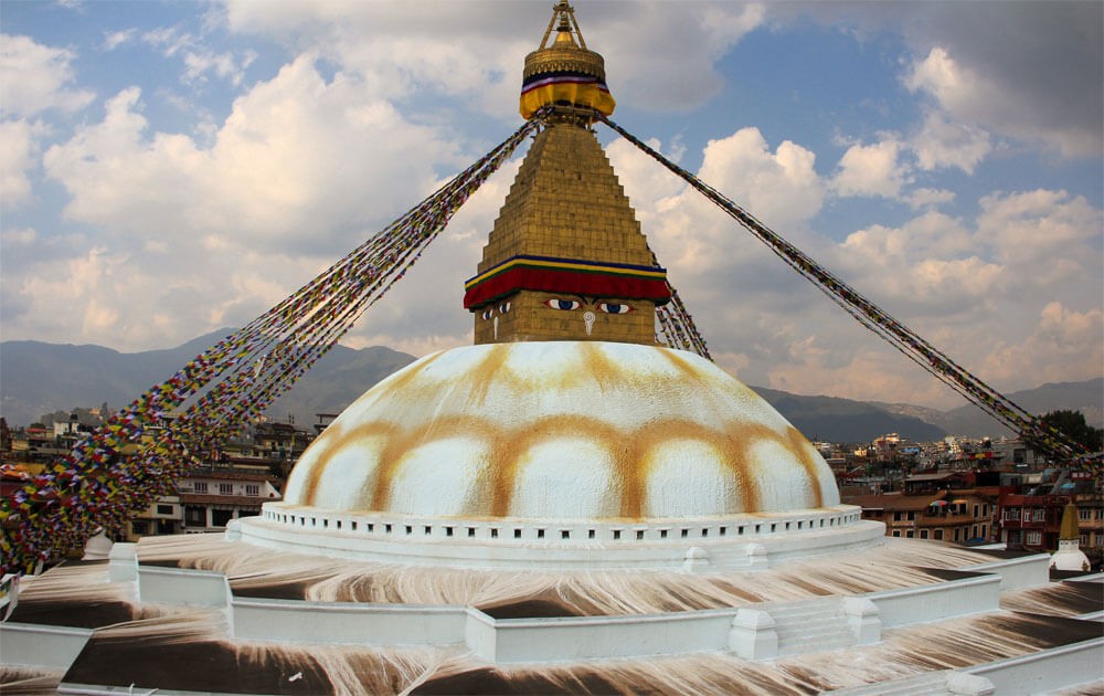 bouddhanath stupa with tibetan buddhist prayer flags visiting on one week nepal tour.