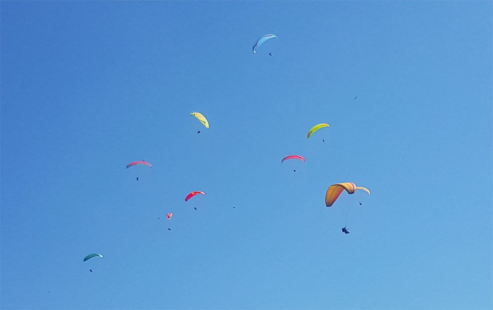 paragligers on the sky above pokhara on paragliding and ultralight flight.
