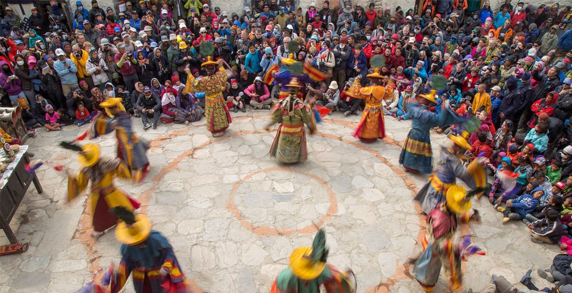 presenting god and evil force dance at the palace yard and audience are watching it.