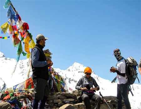 trekkers are at kyanjin ri and white mountain view with the blue sky on a clear day.